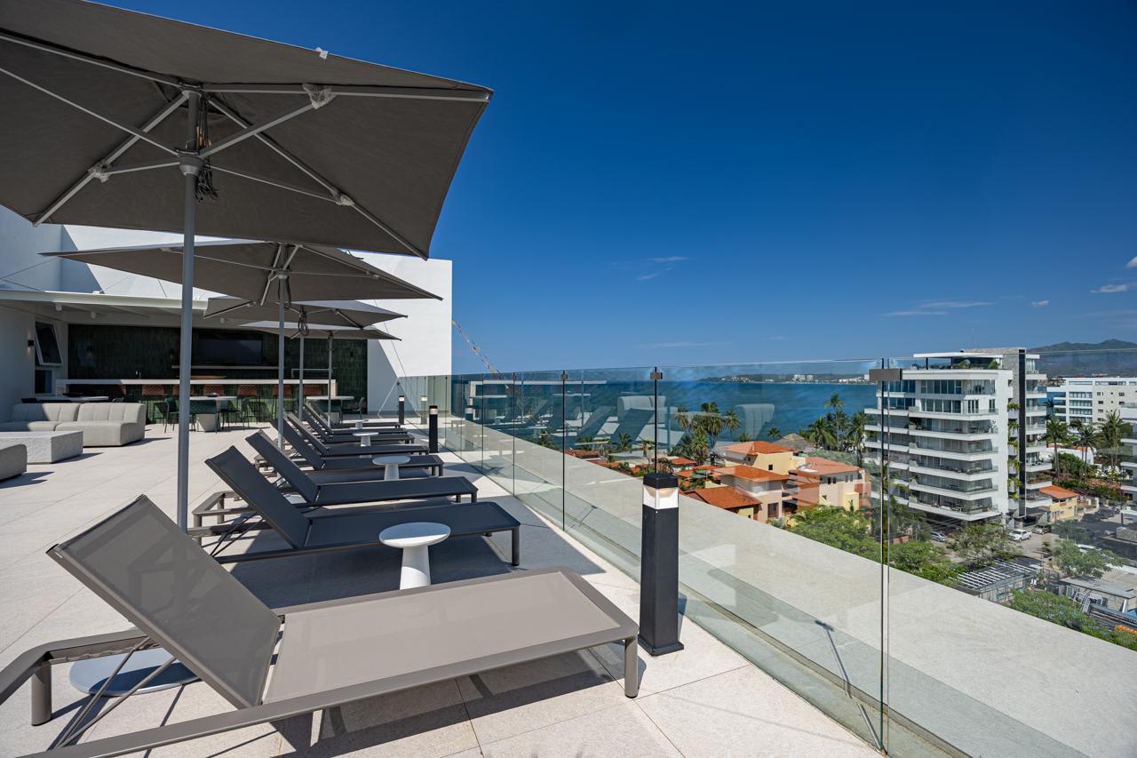 Row of sun loungers on the rooftop terrace overlooking Banderas Bay