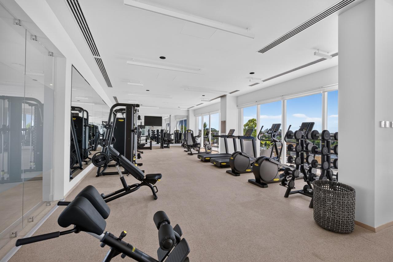 Fitness center with floor-to-ceiling windows and mountain views