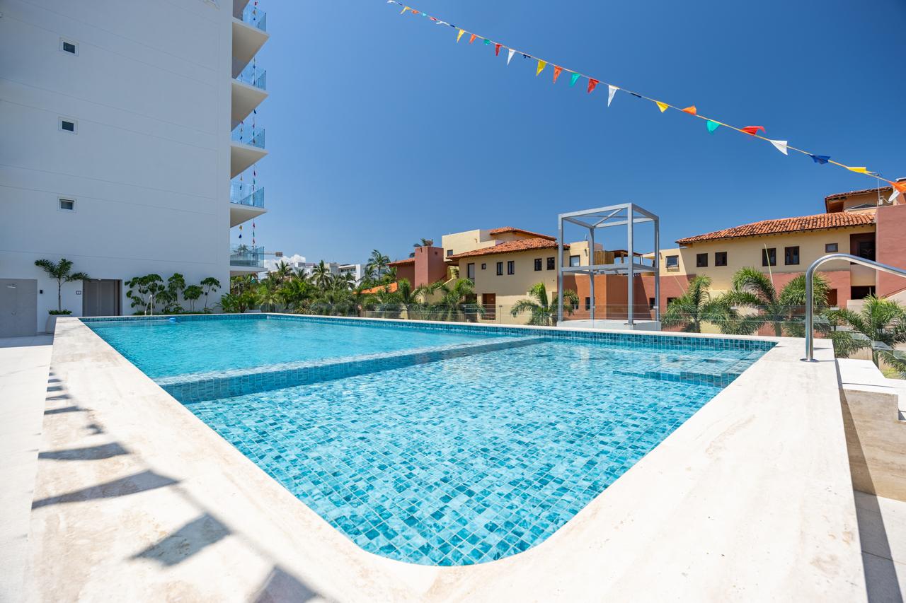 Family pool at Jacana Ocean Life with papel picado overhead