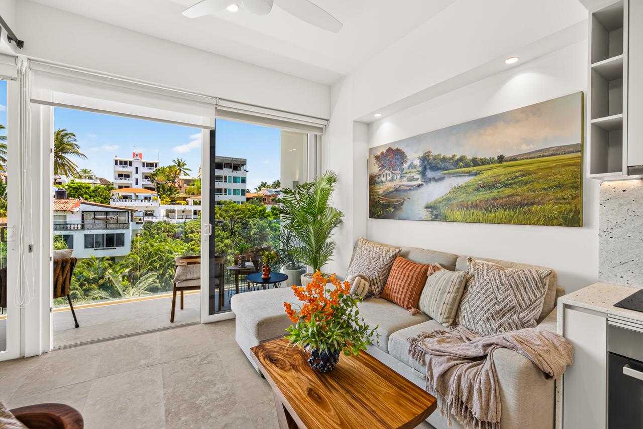Bright living room with sofa opening to a private balcony