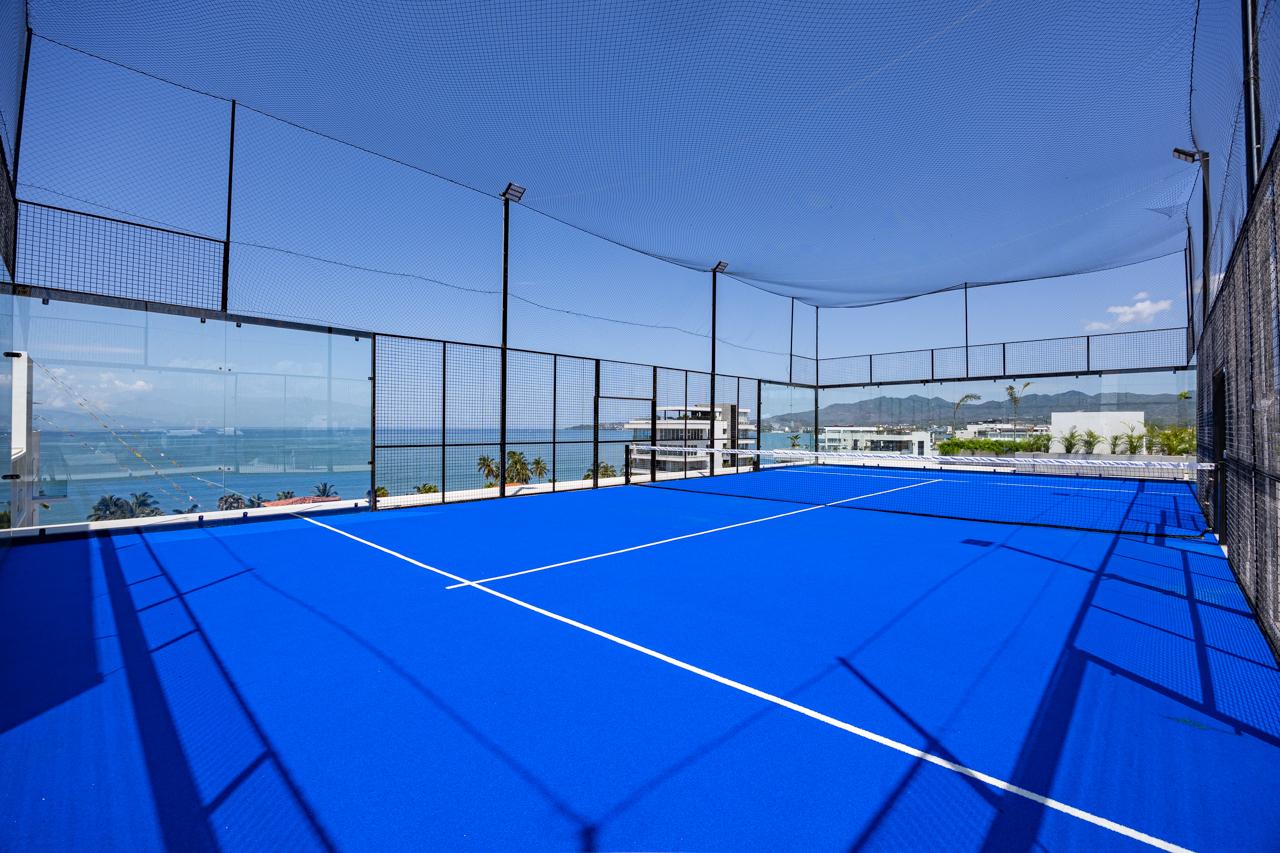 Pickleball court terrace with cafe seating and Banderas Bay backdrop
