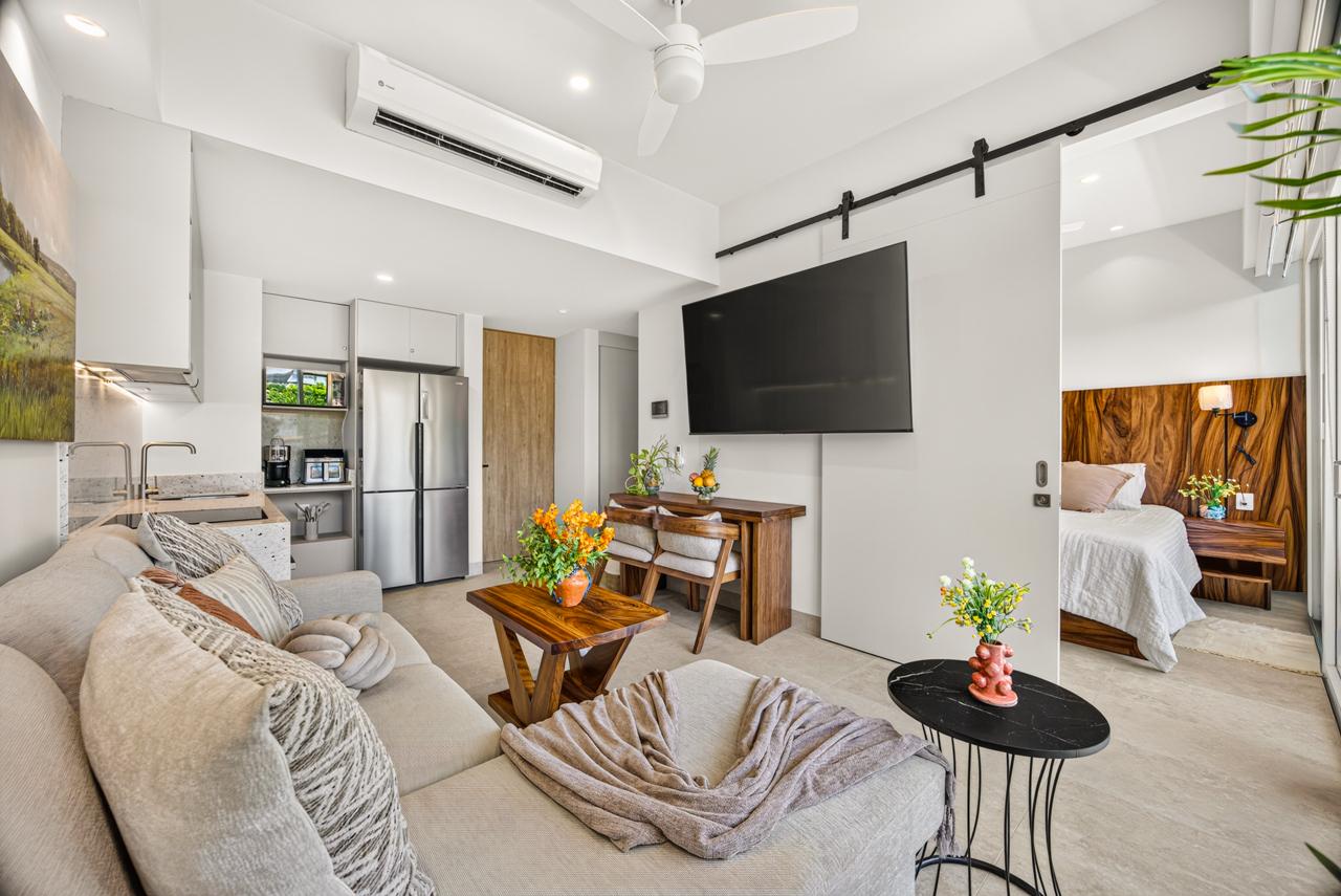 Open-plan living room looking through to the bedroom at Casa Nayah